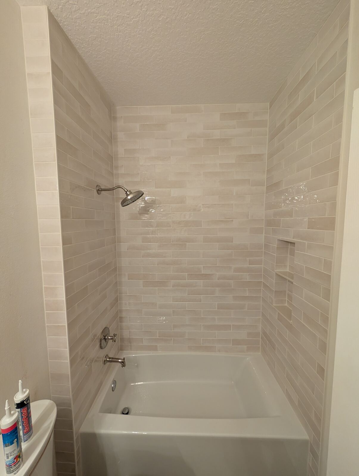 Tile surround installation around bathtub in Ponte Vedra home showing clean grout lines