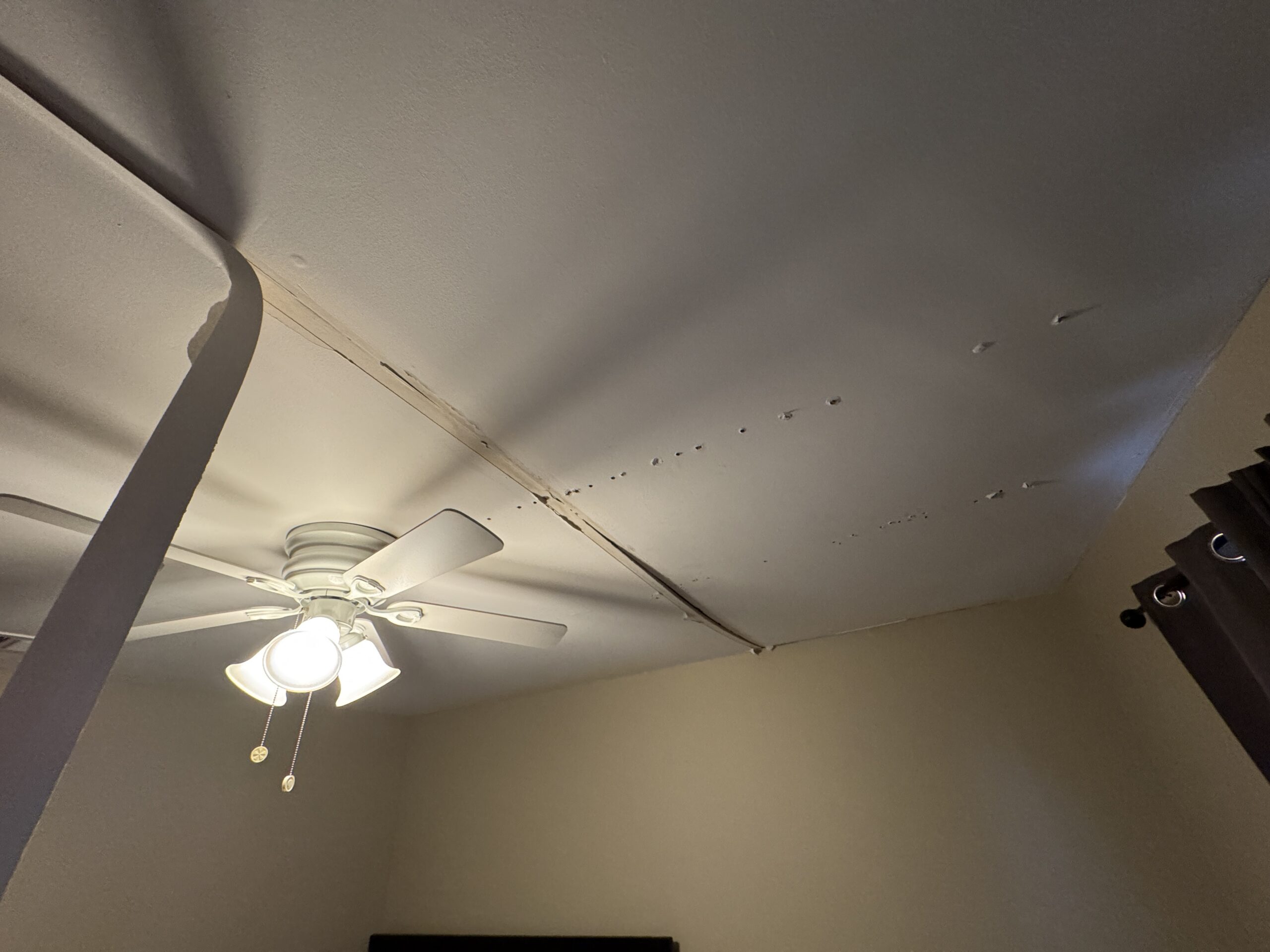 Ponte Vedra Ceiling Tape Repair — And the Sagging Drywall We Found Underneath 4 Sagging drywall being screwed back into the joists during a Ponte Vedra ceiling tape repair, step 3
