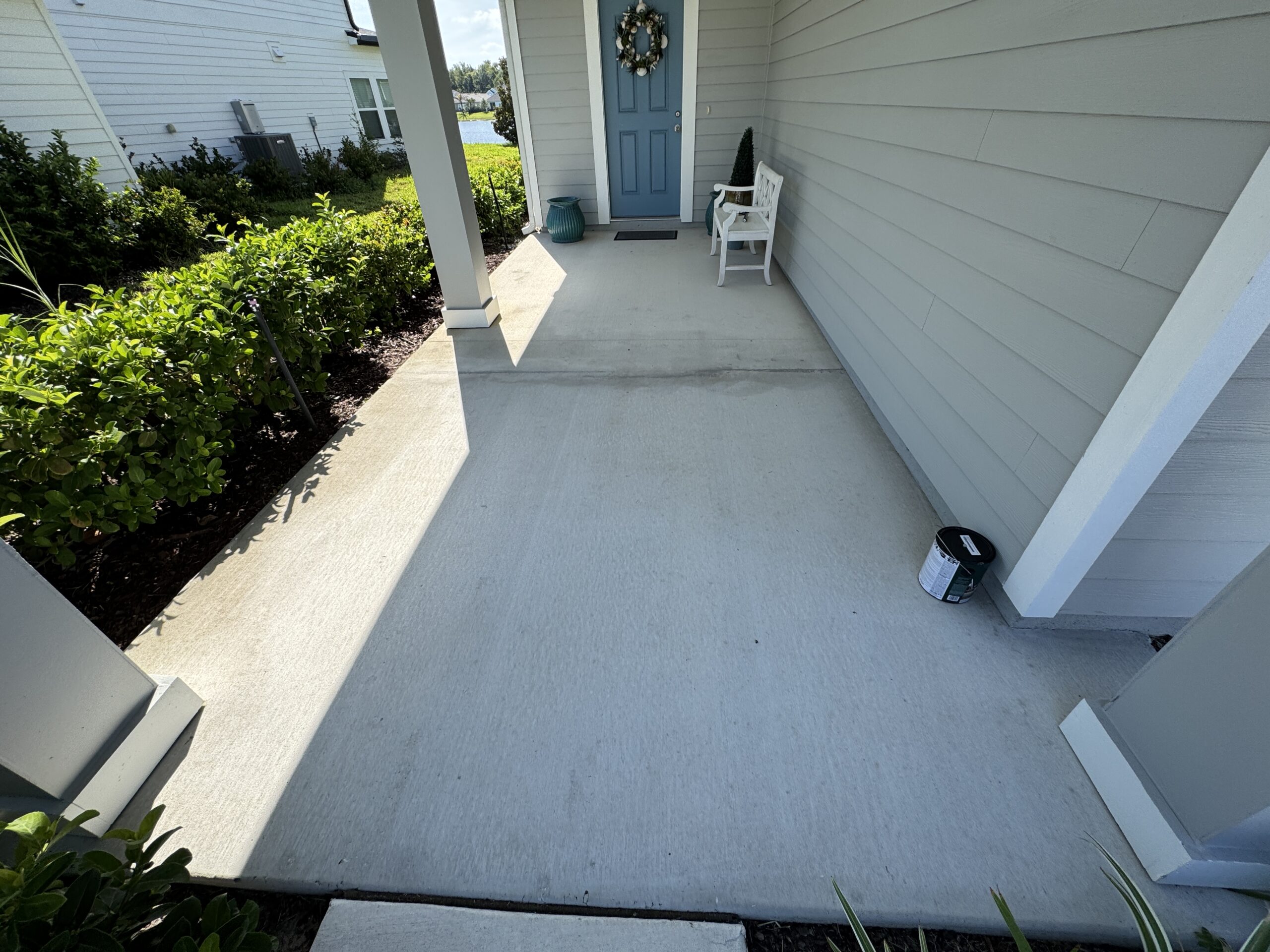 Cracked concrete patio before Nocatee patio painting and sealing